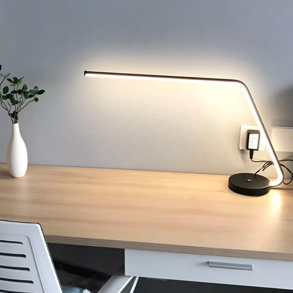 Dimmable Long LED Table Lamp on a desk, providing focused light for work.