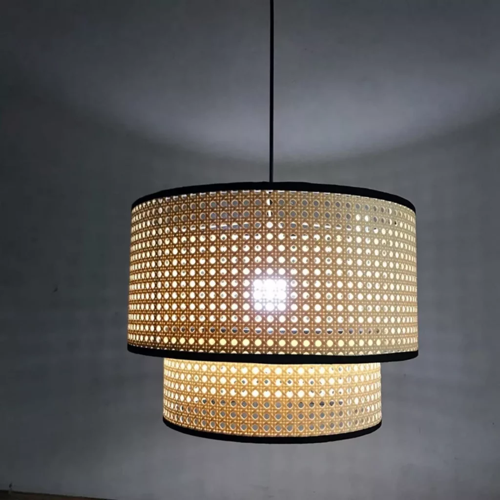 Handmade Rattan Art LED Pendant Light with woven double-layer shade casting warm ambient glow in a minimalist space.