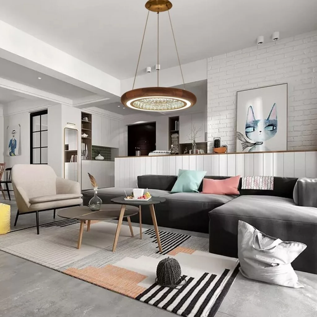 Luxury Crystal Round Wooden Chandelier suspended in a modern living room, encircled by sparkling LED crystals on a walnut wood ring. It illuminates tan leather sofas, glass coffee table, batwing chair, art walls, and calendar against gray walls.