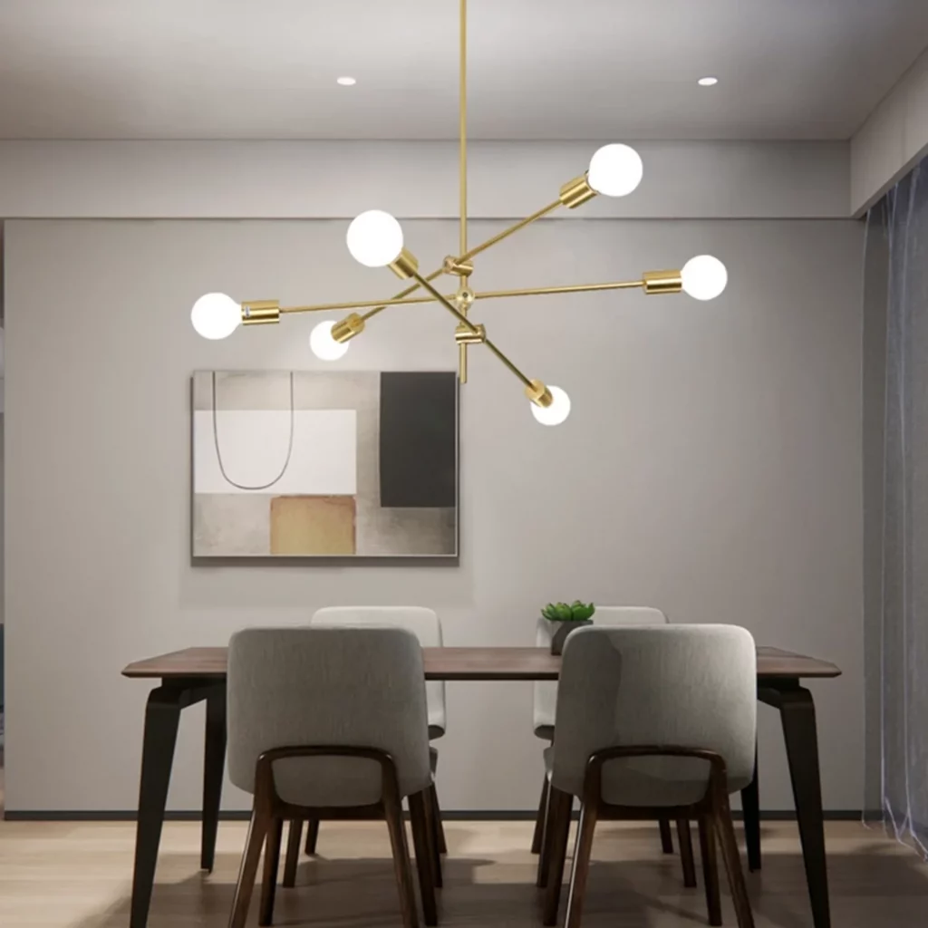 A Nordic Style Black & Gold Sputnik Chandelier with adjustable arms and bare bulbs hangs above a minimalist wooden dining set.