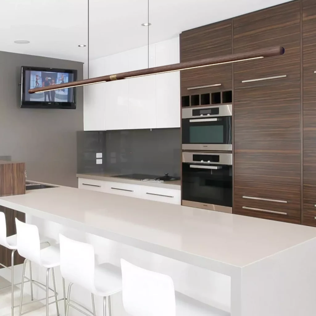 Nordic Long Rod Wooden Chandelier over modern kitchen island with white cabinets and wood paneling minimalist Nordic design lighting fixture