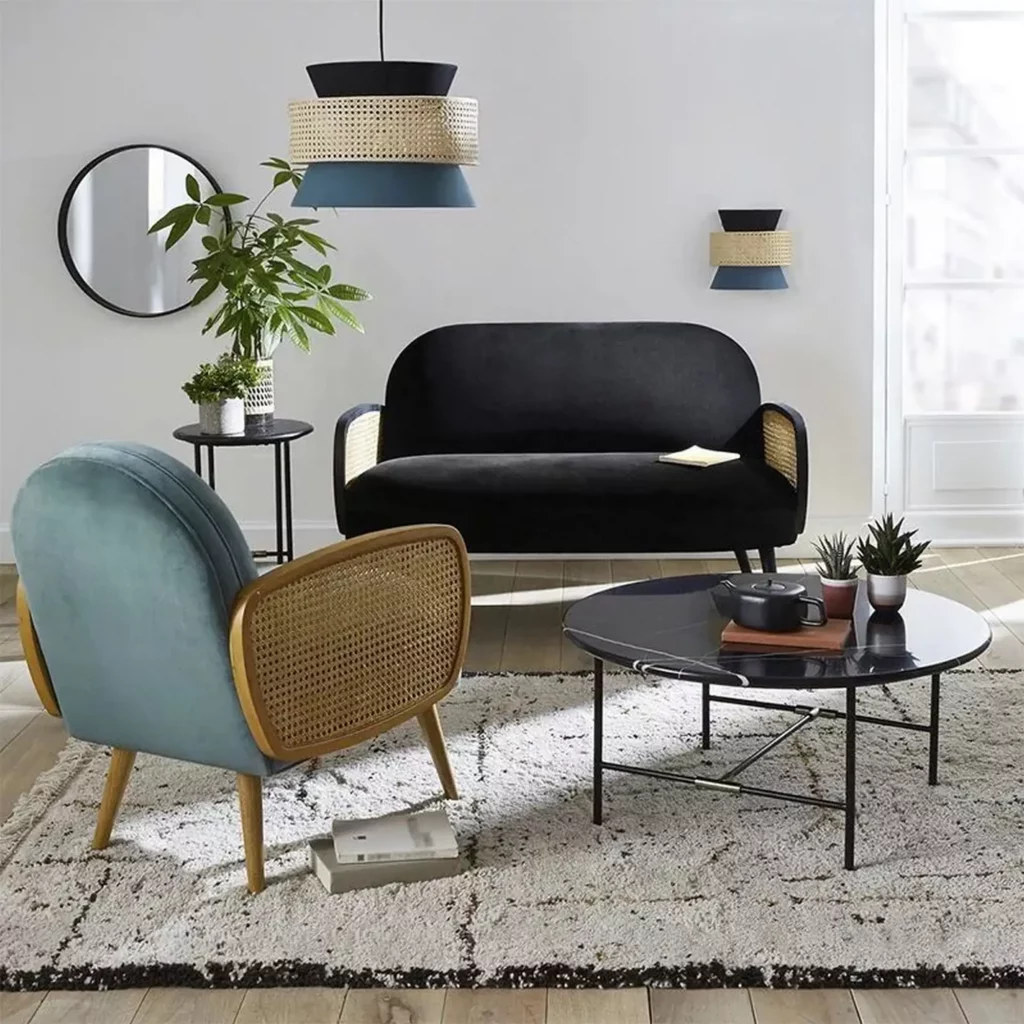 Japanese Style Round Rattan Pendant Light above a Japandi living room with cane chairs and black sofa.