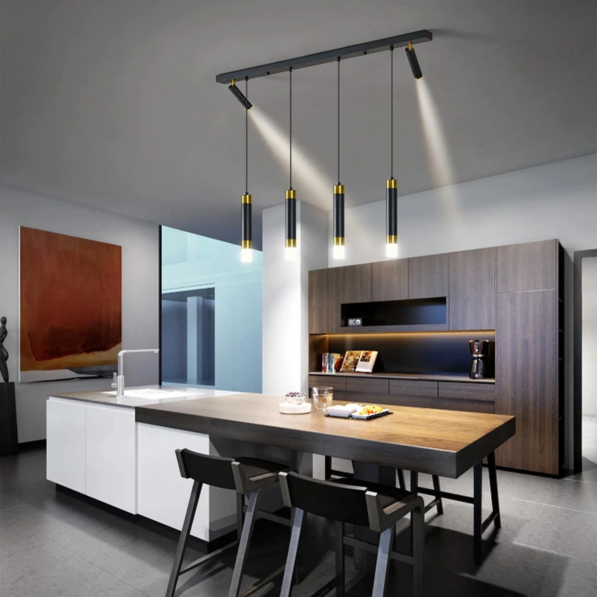 Industrial-style kitchen island lighting featuring four black and gold pendant cylinders and two angled track spotlights.