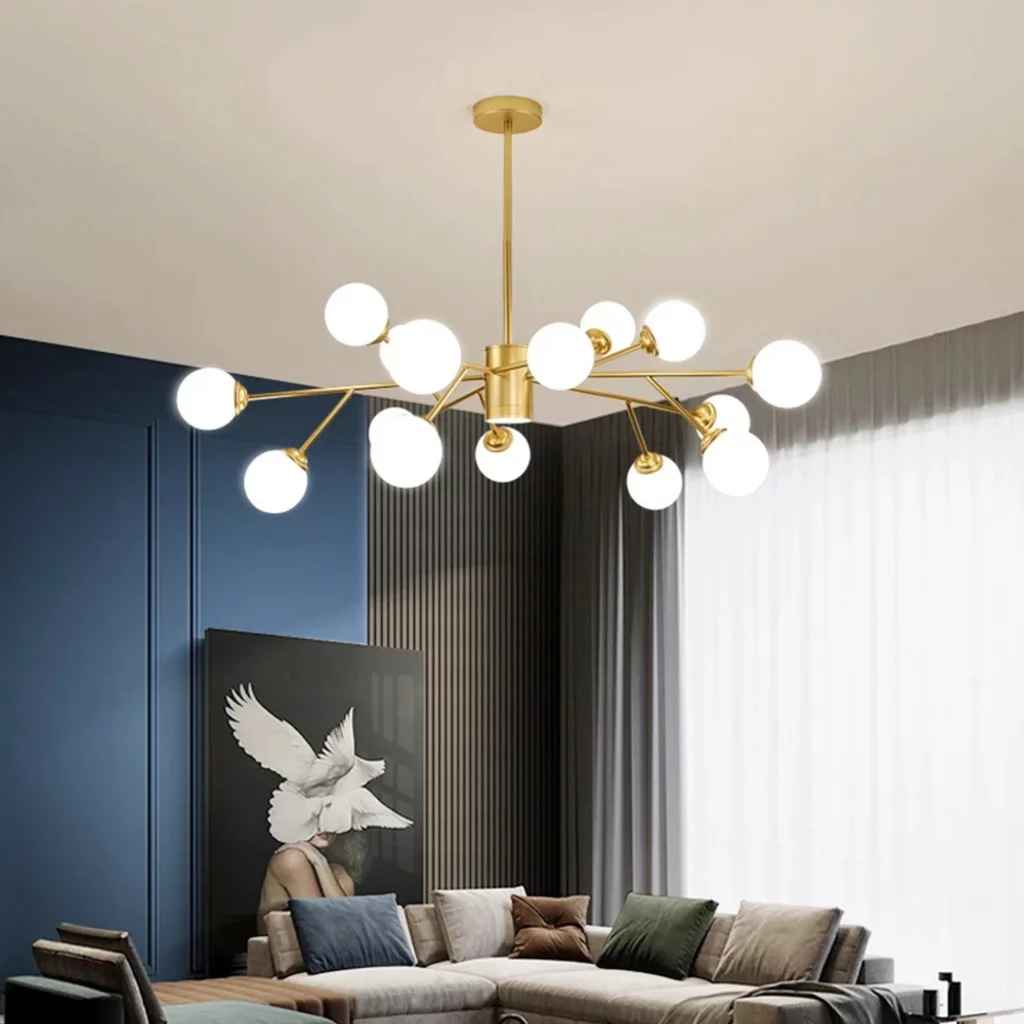 Large contemporary sputnik chandelier with a gold frame and numerous frosted white globe bulbs over a gray sectional sofa