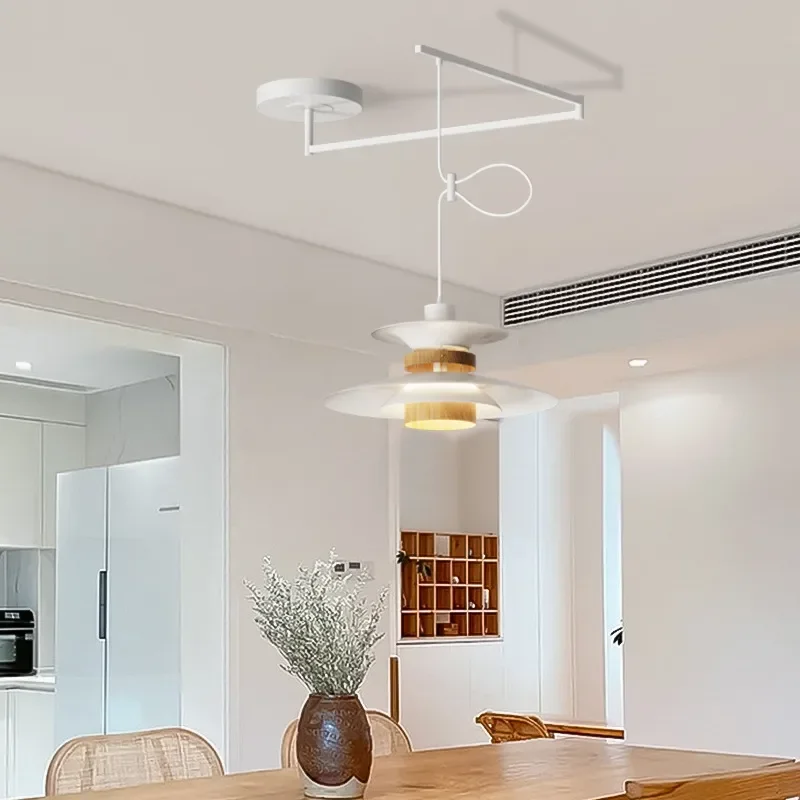 Rocker Arm Dining Pendant Lamp in modern white design hanging over dining table showcasing dynamic adjustable arm and warm ambient lighting
