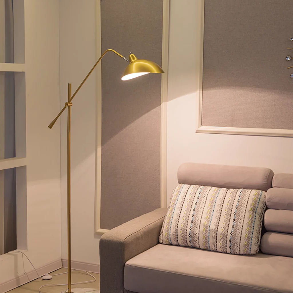 Emisoo European Floor Lamp with a sleek, golden design, illuminating a cozy corner with a modern sofa and soft, neutral tones.