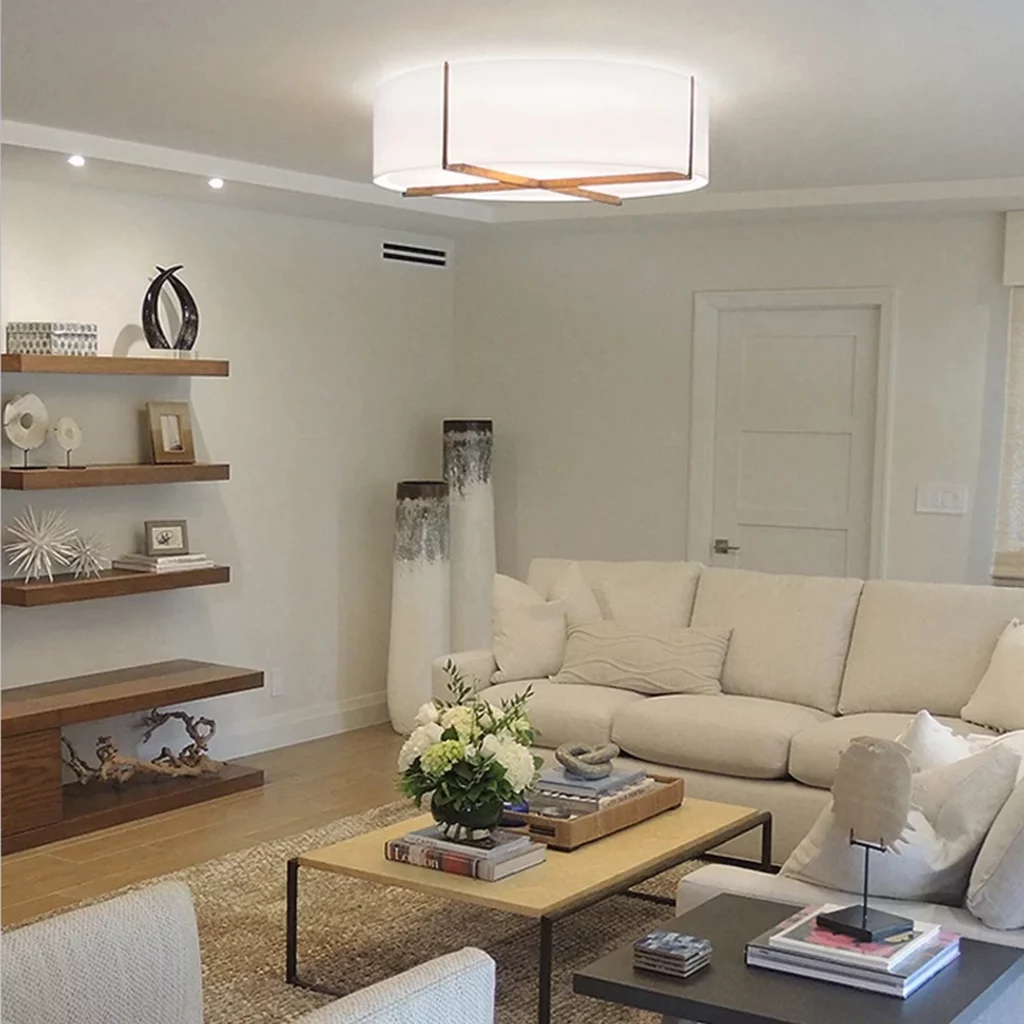 Round Shape Fabric Lampshade Ceiling Lamp with wood accent detail illuminating a cozy neutral living room with beige sofa and modern decor
