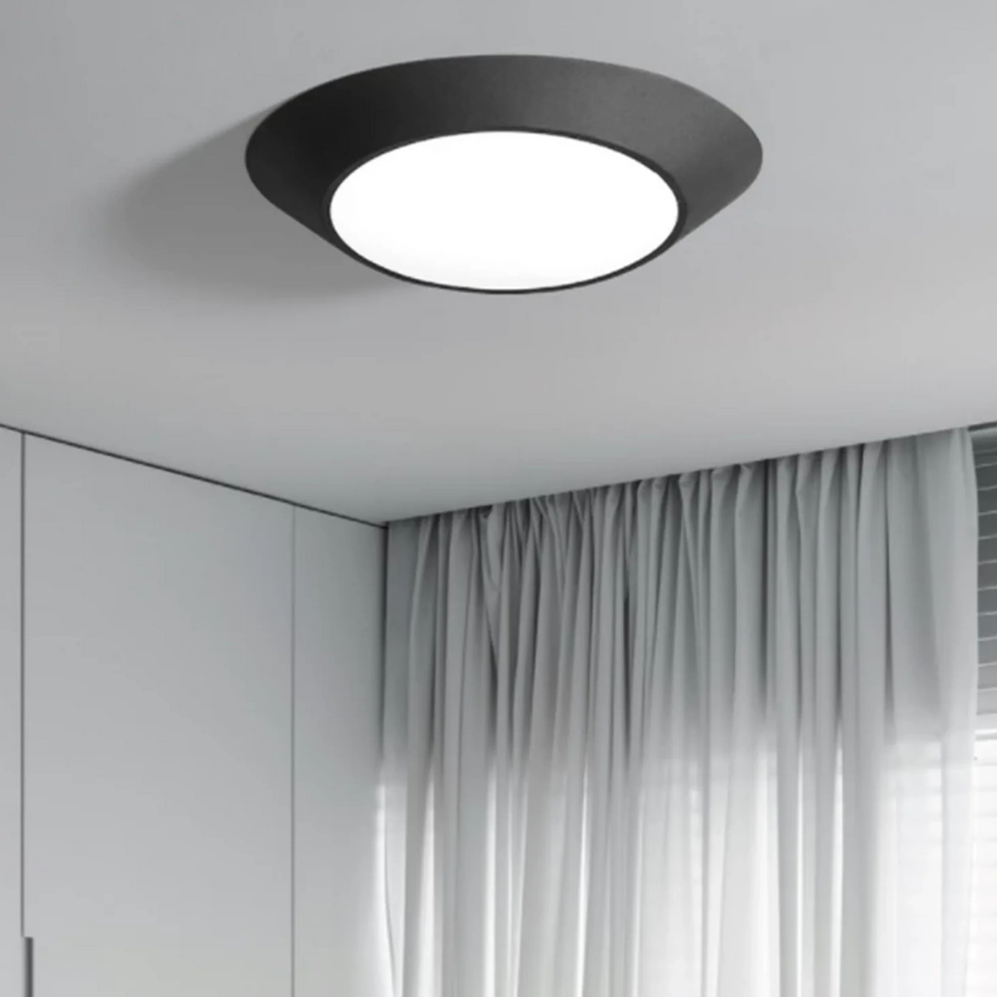 Art Design Geometrical Round Shape Lamp, black modern ceiling light with white diffuser in minimalist room.