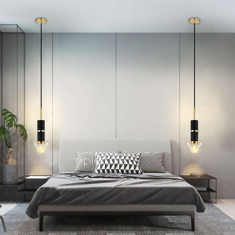 The final image showcases two Crystal Bubble Glass Elegant Pendant Lights flanking a modern bed Each fixture features a sleek black cylindrical body with gold accents suspended by a long cord ending in a glowing crystal bubble glass bulb