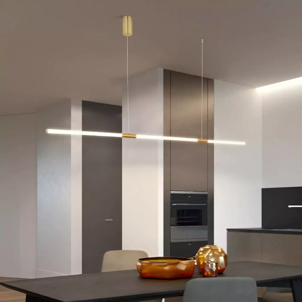 Acrylic Kitchen Island Chandelier with sleek linear LED bar and gold accents, suspended over a modern minimalist kitchen island.