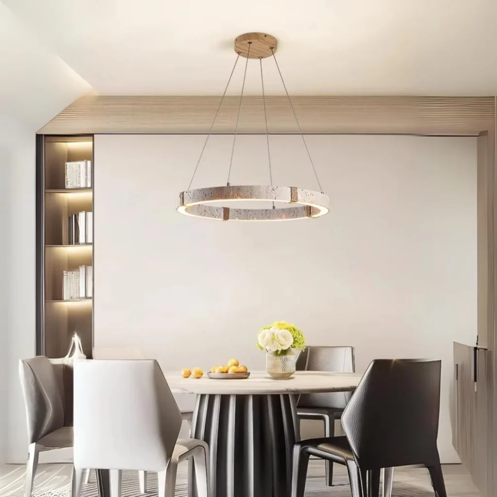 Vouvray Round Chandelier with suspended circular LED ring and textured finish illuminating a modern dining room interior
